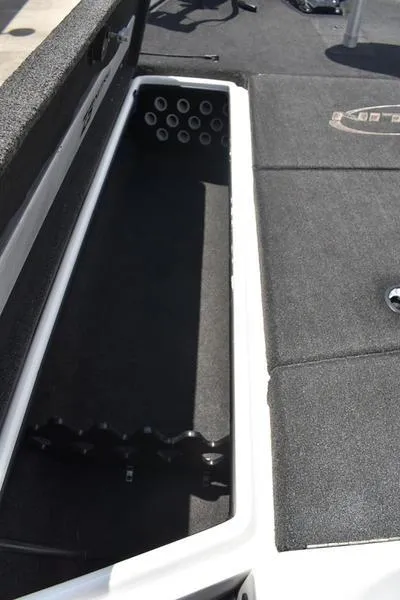 Slide: The Image of 2008 Nitro z9cdc boat storage compartment with rod holders, black interior. - 24