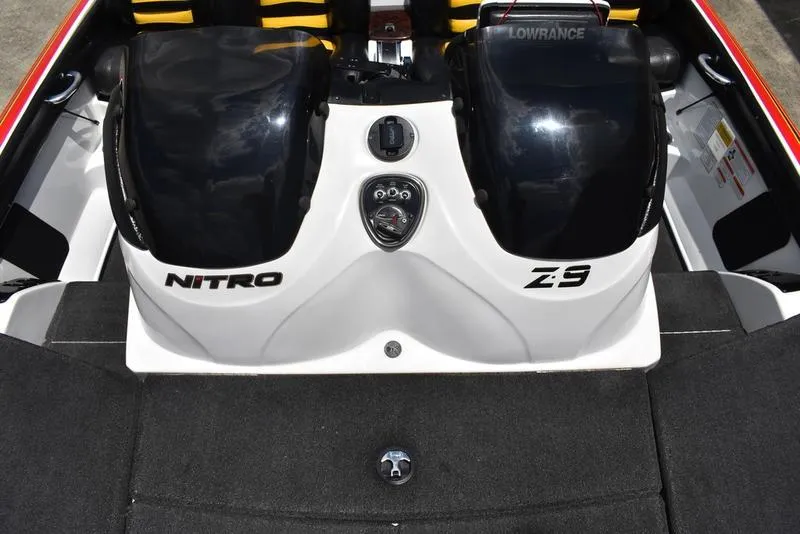 Slide: The Image of 2008 Nitro Z9CDC boat interior with dual black engine covers and Lowrance equipment. - 29