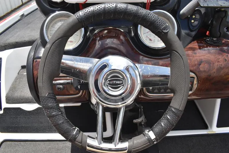 Slide: The Image of 2008 Nitro z9cdc boat steering wheel with gauges and wood finish dashboard. - 36
