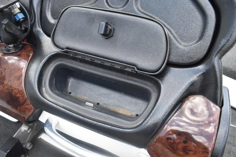 Slide: The Image of 2008 Nitro z9cdc dashboard compartment with open storage and wood accents. - 44