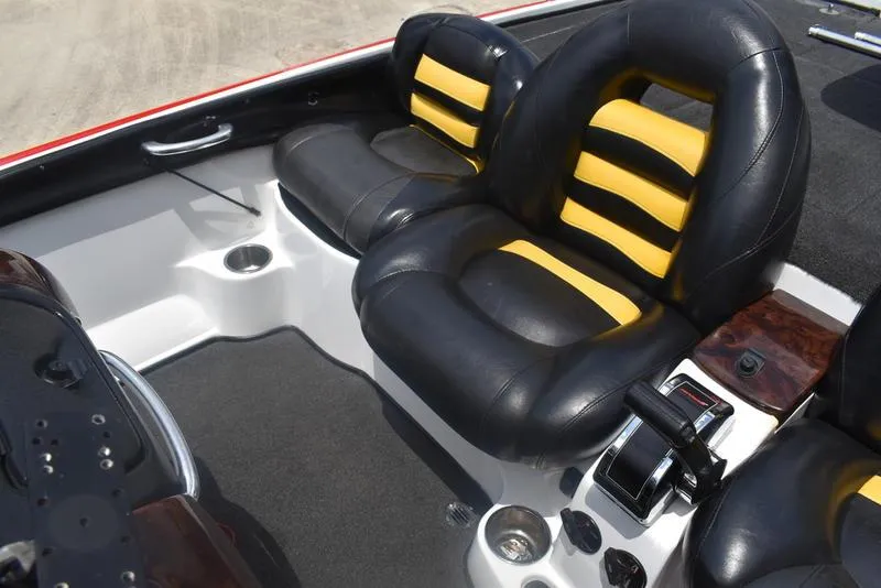 Slide: The Image of 2008 Nitro Z9 CDC boat interior with black and yellow seats, control panel, and cup holders. - 46