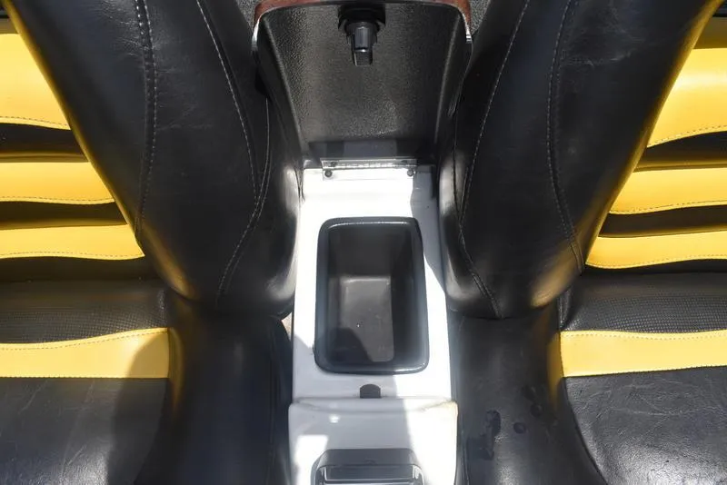 Slide: The Image of Black and yellow seats with center console in 2008 Nitro Z9 CDC boat. - 48