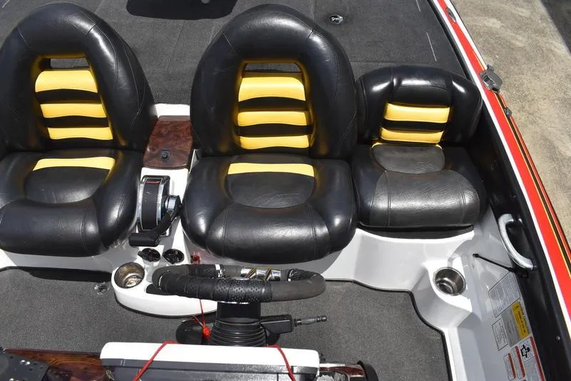 Slide: The Image of 2008 Nitro z9cdc boat interior with black and yellow seats, steering wheel, and controls. - 49