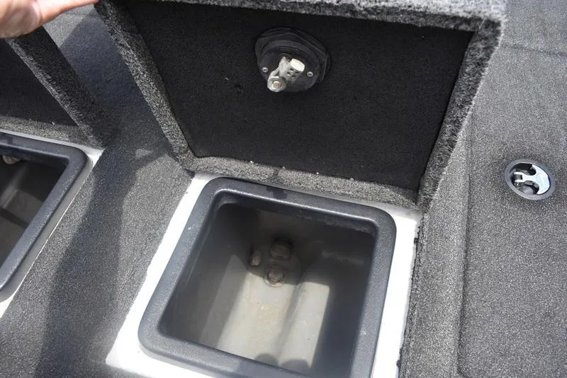 Slide: The Image of 2008 Nitro z9cdc boat storage compartment with open lid and visible latch. - 56
