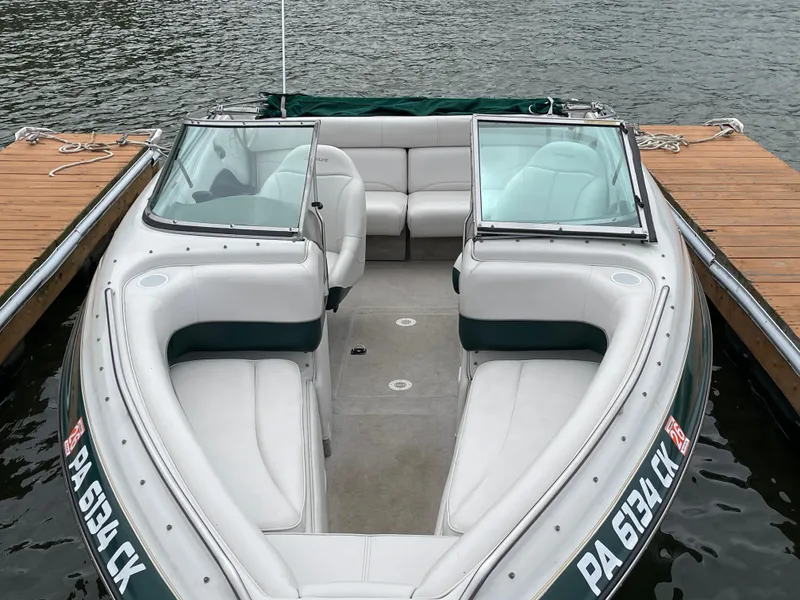 Slide: The Image of 2001 Crownline 202 BR boat docked, featuring spacious seating and sleek design. - 2