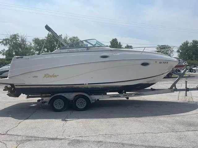 Slide: The Image of 2002 Rinker 250 FV boat on trailer in parking lot, side view. - 3