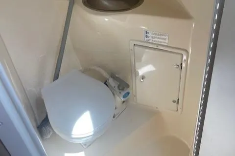 Slide: The Image of 2002 Rinker 250 FV boat bathroom with toilet and sink. - 6