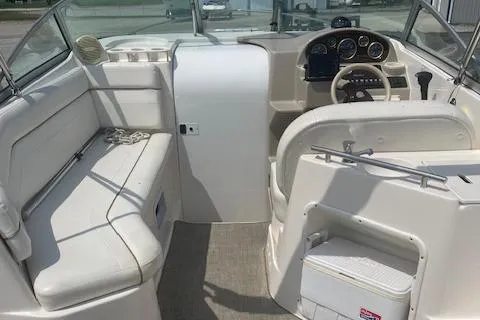 Slide: The Image of 2002 Rinker 250 FV boat interior with seating, steering wheel, and dashboard. - 9