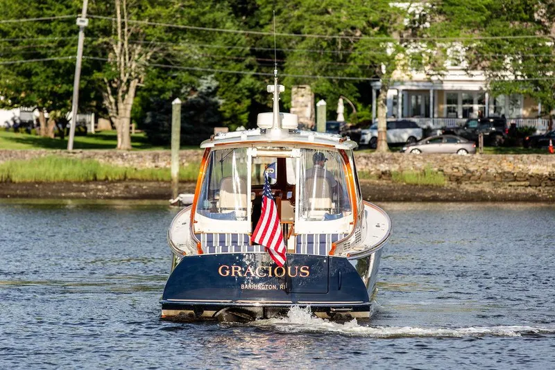 Slide: The Image of 2011 Hinckley Picnic Boat Mark III cruising on a scenic waterway. - 20