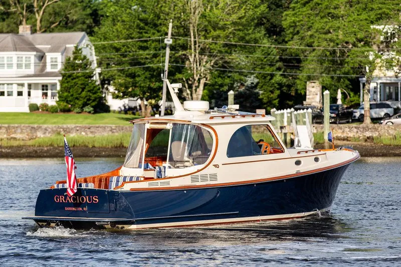 Slide: The Image of 2011 Hinckley Picnic Boat Mark III cruising on a scenic river. - 22