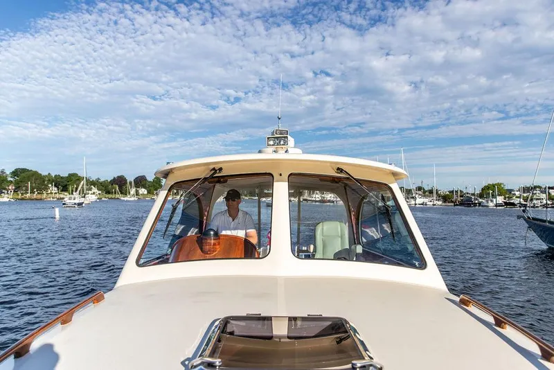 Slide: The Image of 2011 Hinckley Picnic Boat Mark III cruising on a sunny day with scenic harbor views. - 24