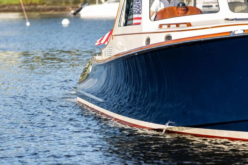 Slide: The Image of Hinckley Picnic Boat Mark III 2011 cruising on calm water, showcasing elegant design. - 25