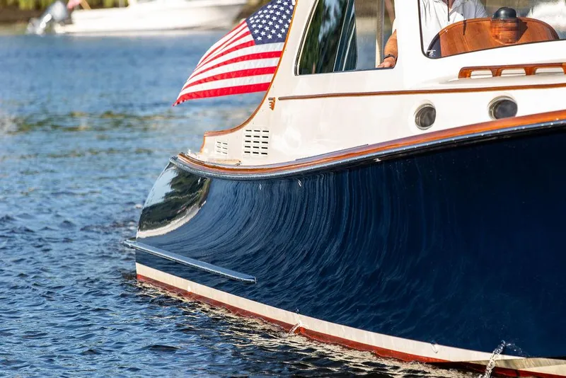 Slide: The Image of 2011 Hinckley Picnic Boat Mark III on water with American flag. - 28