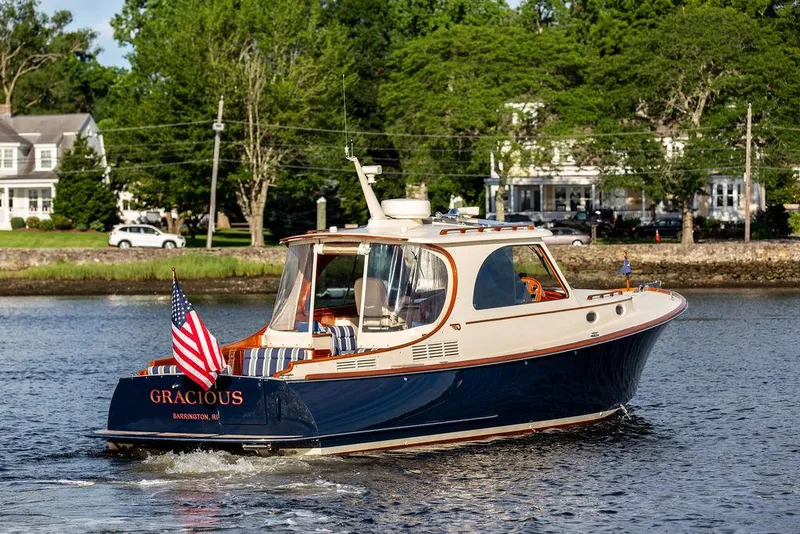 Slide: The Image of 2011 Hinckley Picnic Boat Mark III cruising on a scenic waterway. - 4