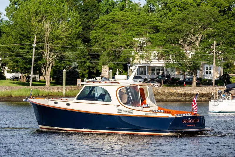 Slide: The Image of 2011 Hinckley Picnic Boat Mark III cruising on a scenic river. - 15