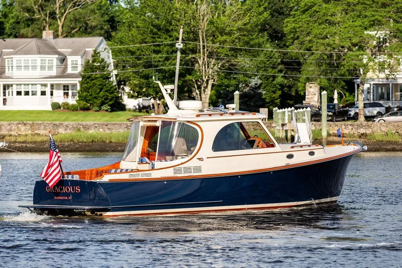 Slide: The Image of Hinckley Picnic Boat Mark III 2011 cruising on a scenic river with lush greenery. - 23