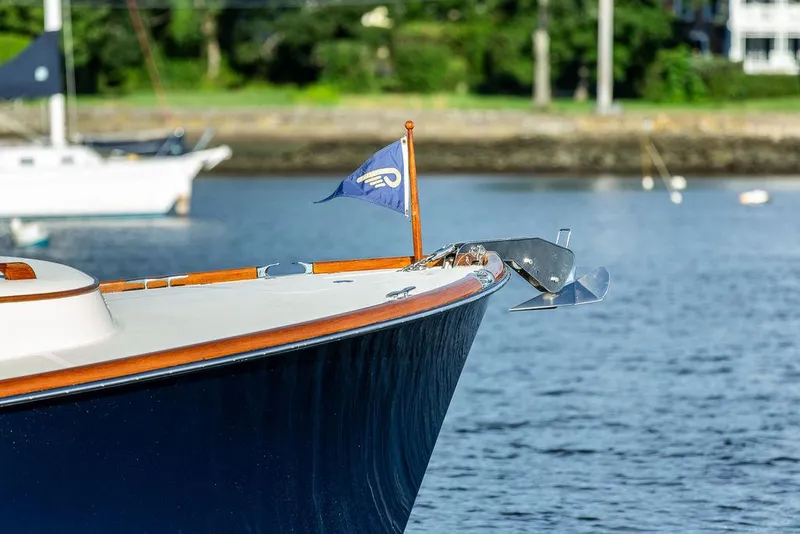 Slide: The Image of Hinckley Picnic Boat Mark III 2011, elegant bow with flag, anchored on calm water. - 27