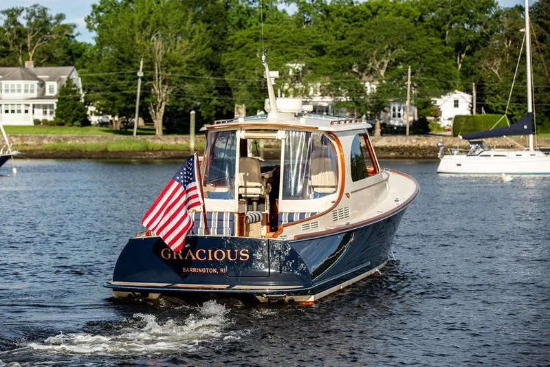Slide: The Image of Hinckley Picnic Boat Mark III 2011 cruising on water with American flag displayed. - 3