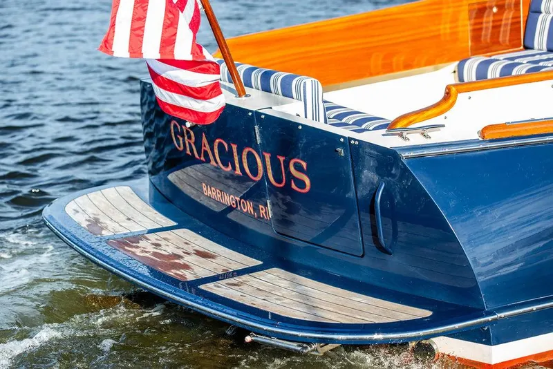 Slide: The Image of Hinckley Picnic Boat Mark III, 2011, with American flag, named "Gracious," docked in water. - 30