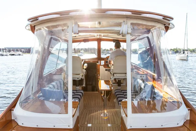 Slide: The Image of Hinckley Picnic Boat Mark III, 2011, interior view with clear canopy and seating, on water. - 37