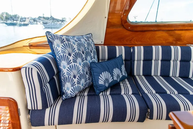 Slide: The Image of Interior of 2011 Hinckley Picnic Boat Mark III with striped seating and decorative pillows. - 41
