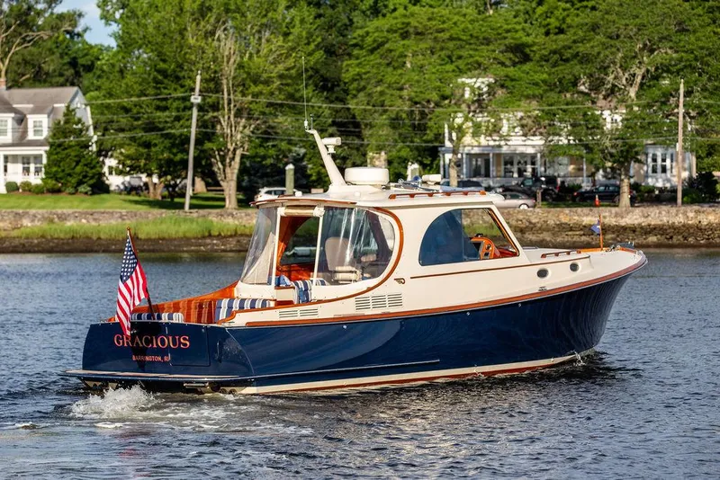 Slide: The Image of 2011 Hinckley Picnic Boat Mark III cruising on a scenic river. - 5