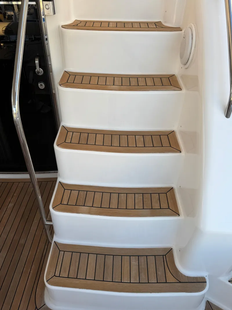 Slide: The Image of Staircase on 2012 Neptunus 62 Flybridge yacht with teak steps and stainless steel railing. - 14