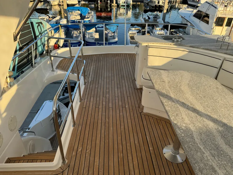 Slide: The Image of Luxurious 2012 Neptunus 62 Flybridge yacht with spacious deck and marina view. - 15