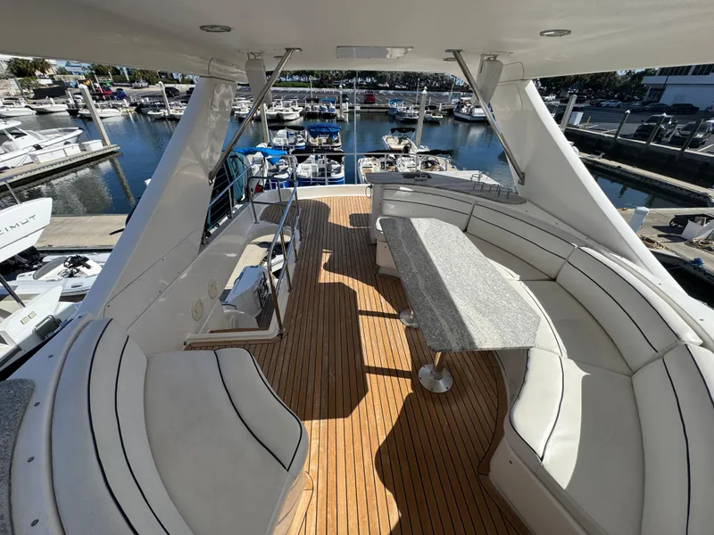 Slide: The Image of Luxurious 2012 Neptunus 62 Flybridge yacht with spacious seating and elegant design at marina. - 16