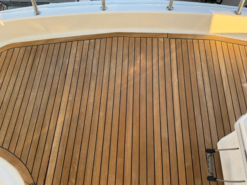Slide: The Image of Teak deck of 2012 Neptunus 62 Flybridge yacht, featuring sleek wooden finish. - 17