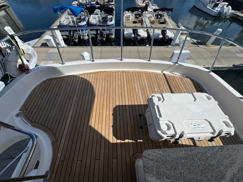 Slide: The Image of Flybridge deck of 2012 Neptunus 62 yacht with wooden flooring and cooler. - 18