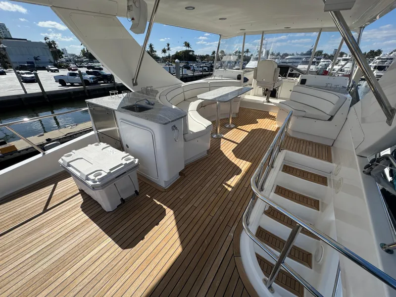 Slide: The Image of Luxurious 2012 Neptunus 62 Flybridge yacht interior with seating, table, and kitchenette. - 24