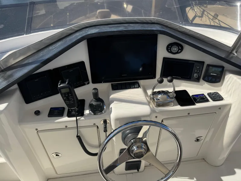 Slide: The Image of Control panel of 2012 Neptunus 62 Flybridge yacht with steering wheel and navigation equipment. - 26