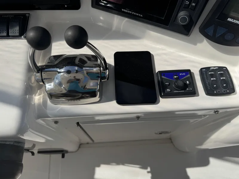 Slide: The Image of Control panel of a 2012 Neptunus 62 Flybridge yacht with throttle and electronic controls. - 27