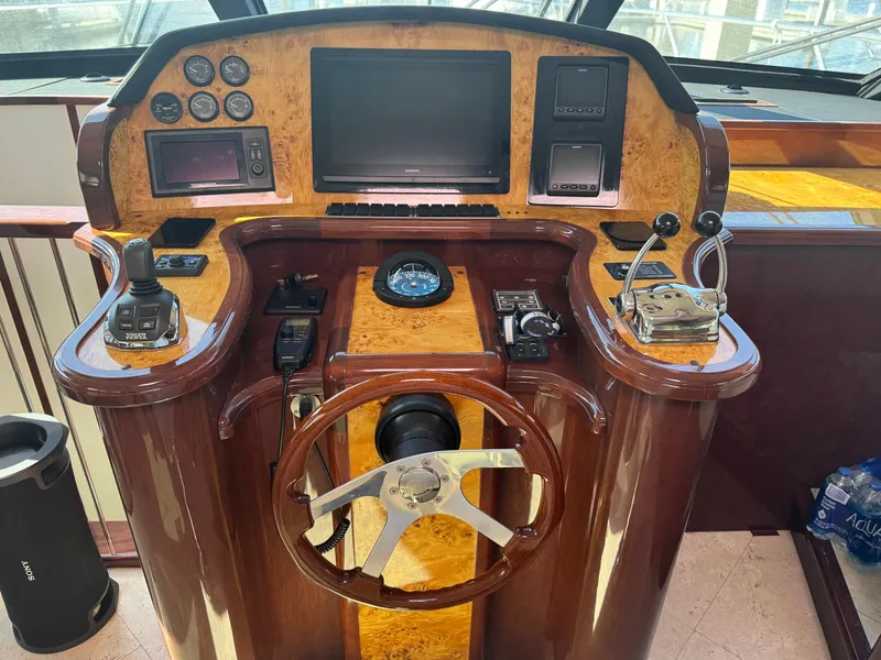Slide: The Image of Helm of 2012 Neptunus 62 Flybridge yacht with navigation controls and steering wheel. - 35