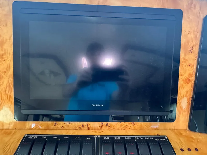 Slide: The Image of Garmin display on 2012 Neptunus 62 Flybridge yacht dashboard with control switches. - 44