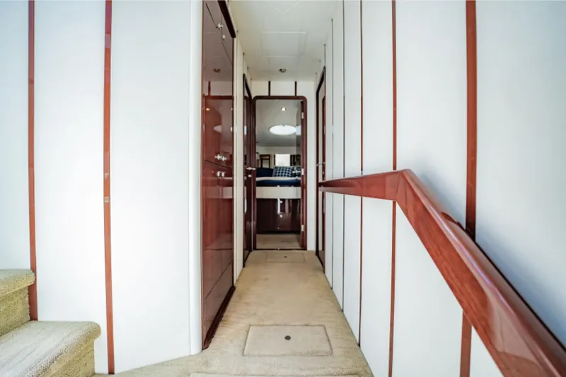 Slide: The Image of Interior hallway of 2012 Neptunus 62 Flybridge yacht with wood accents and carpeted floor. - 53