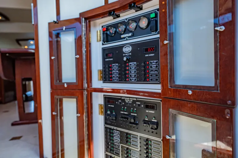 Slide: The Image of Electrical panel on 2012 Neptunus 62 Flybridge yacht with wooden cabinet. - 54