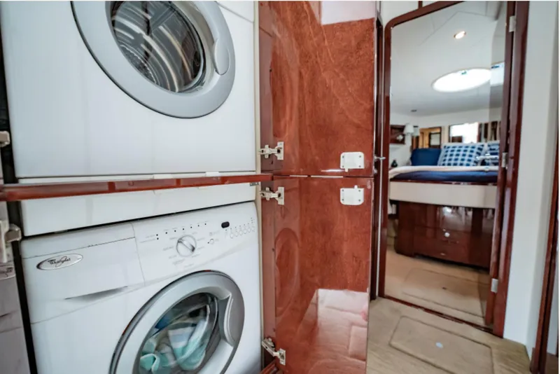 Slide: The Image of Laundry area in 2012 Neptunus 62 Flybridge yacht with washer and dryer. - 55