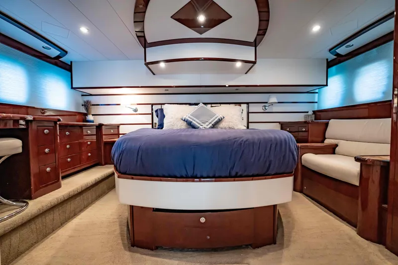 Slide: The Image of Luxurious 2012 Neptunus 62 Flybridge yacht bedroom with elegant wood furnishings and plush bedding. - 56