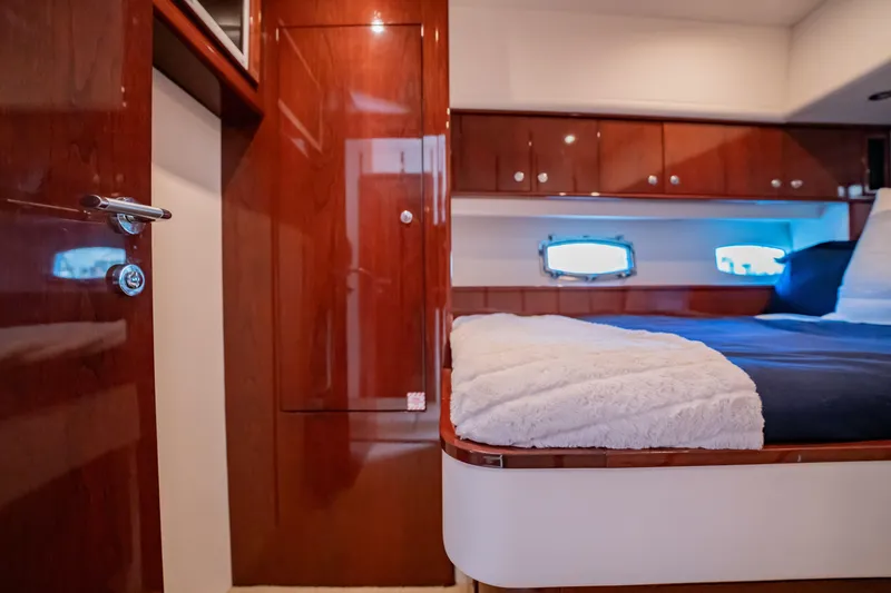 Slide: The Image of Luxurious 2012 Neptunus 62 Flybridge yacht bedroom with polished wood finish. - 59
