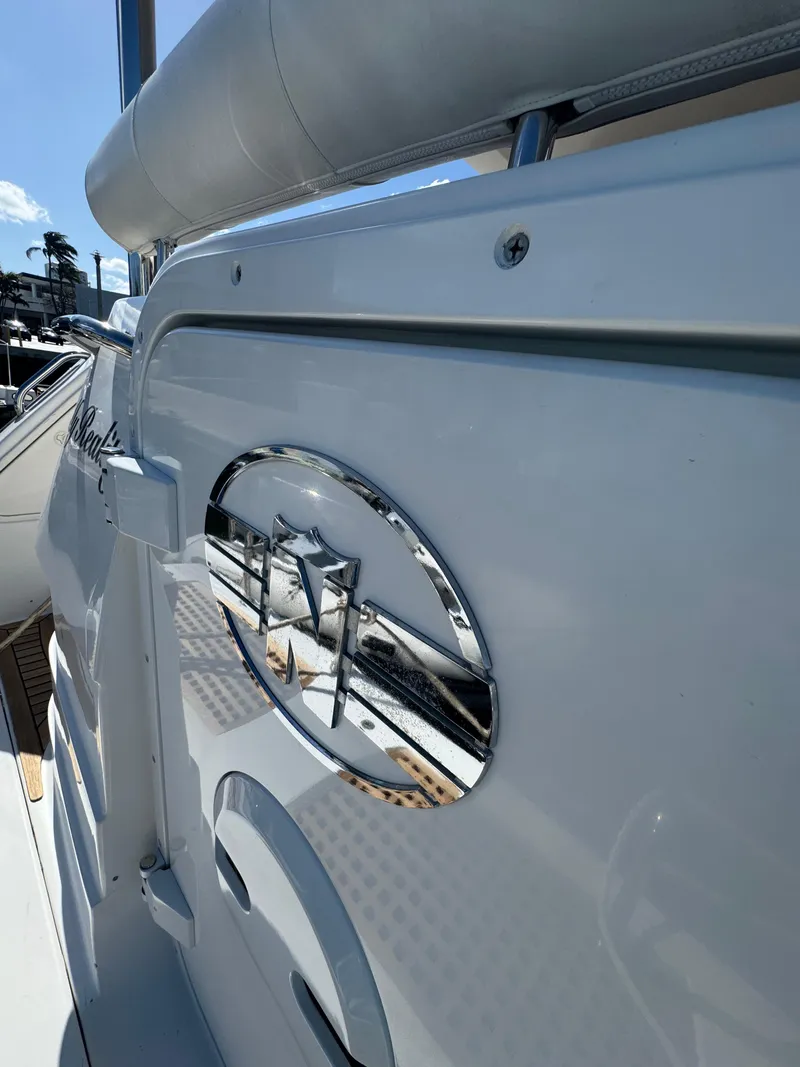 Slide: The Image of 2012 Neptunus 62 Flybridge yacht detail with chrome emblem and sleek design. - 72