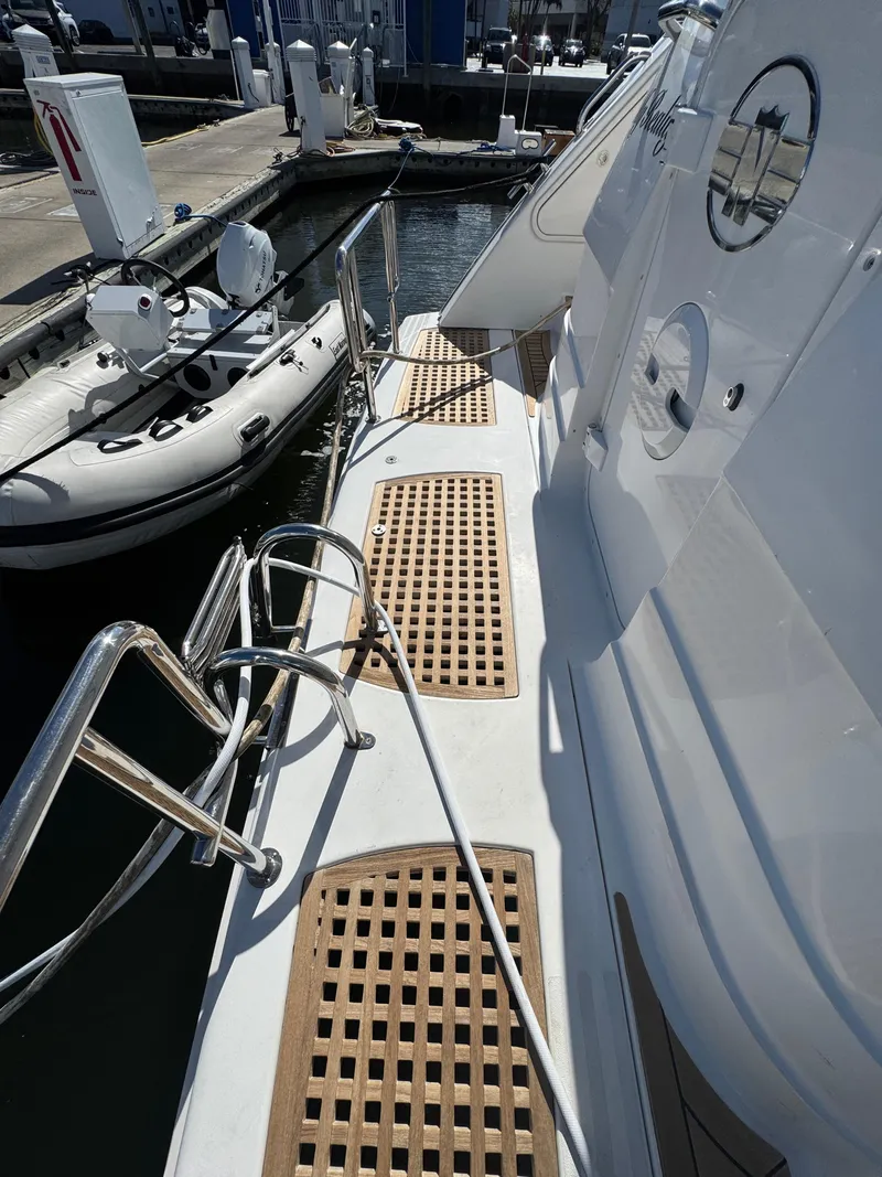 Slide: The Image of Neptunus 62 Flybridge 2012 yacht docked, featuring teak decking and stainless steel railings. - 73