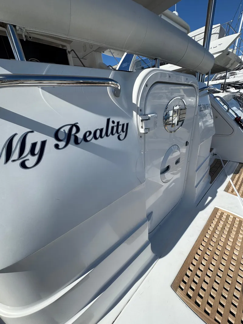 Slide: The Image of 2012 Neptunus 62 Flybridge yacht, side view with "My Reality" text. - 74