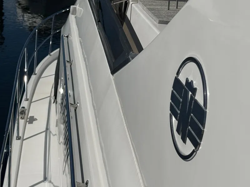 Slide: The Image of 2012 Neptunus 62 Flybridge yacht, side view with logo and railing. - 75
