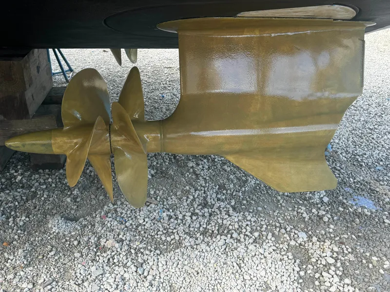 Slide: The Image of Close-up of 2012 Neptunus 62 Flybridge propeller and rudder on gravel surface. - 79