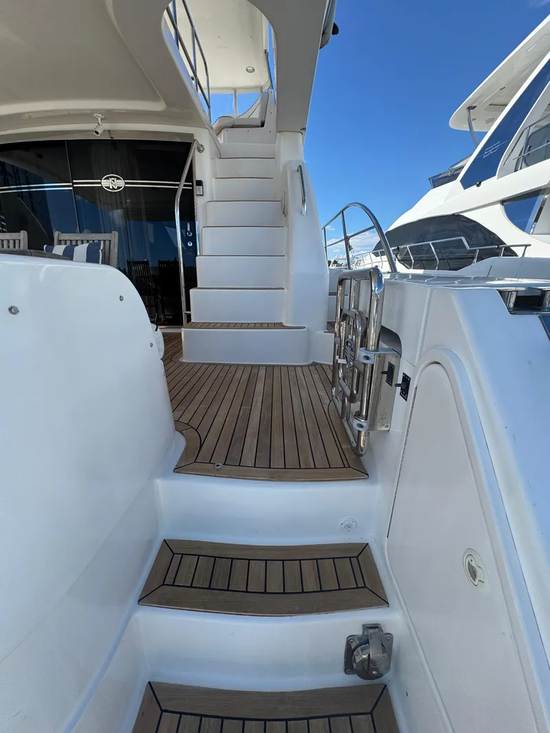 Slide: The Image of Staircase on 2012 Neptunus 62 Flybridge yacht with teak decking and stainless steel railings. - 8