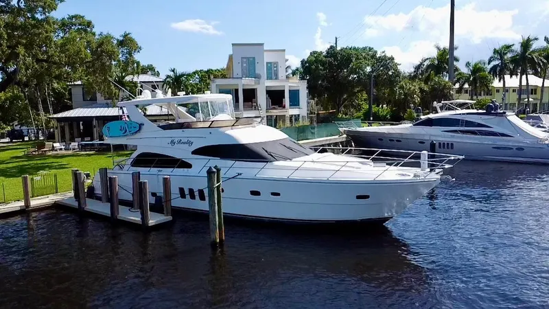 Slide: The Image of Neptunus 62 Flybridge yacht docked by waterfront homes, 2012 model. - 83