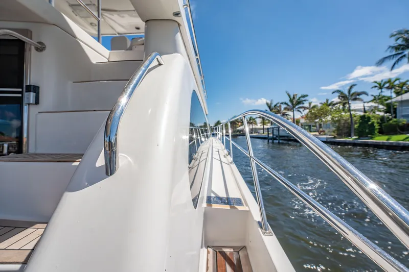 Slide: The Image of Side view of 2012 Neptunus 62 Flybridge yacht with sleek railing and sunny waterfront. - 9