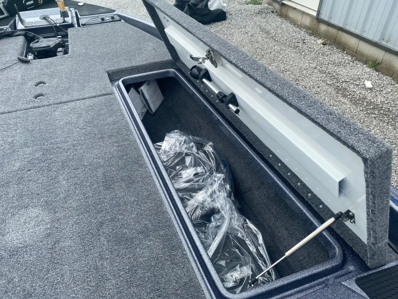 Slide: The Image of Open storage compartment in 2026 Phoenix 721 ZXL boat, showing interior details and equipment. - 15